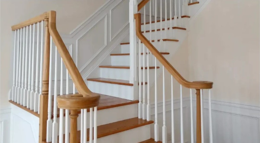 Oak handrail with white balusters on a two run stair